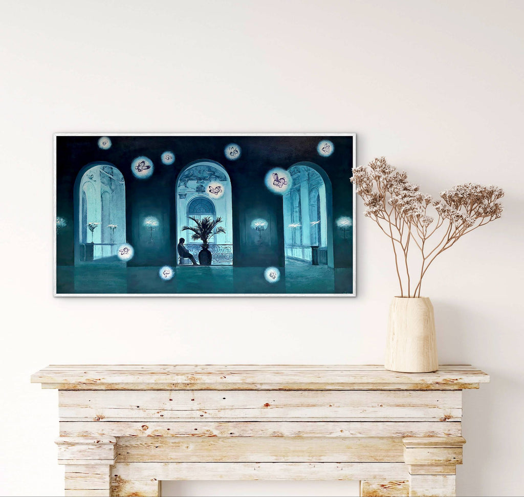 Television mounted on a wall with a decorative plant on a wooden console table below.