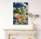 Framed artwork of a woman with a red inner tube on a wall above a wooden console table.