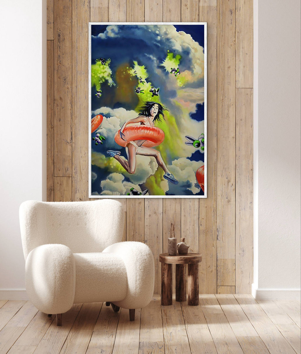 Poster of a woman with an inner tube on a cloud against a wooden wall with a white armchair.