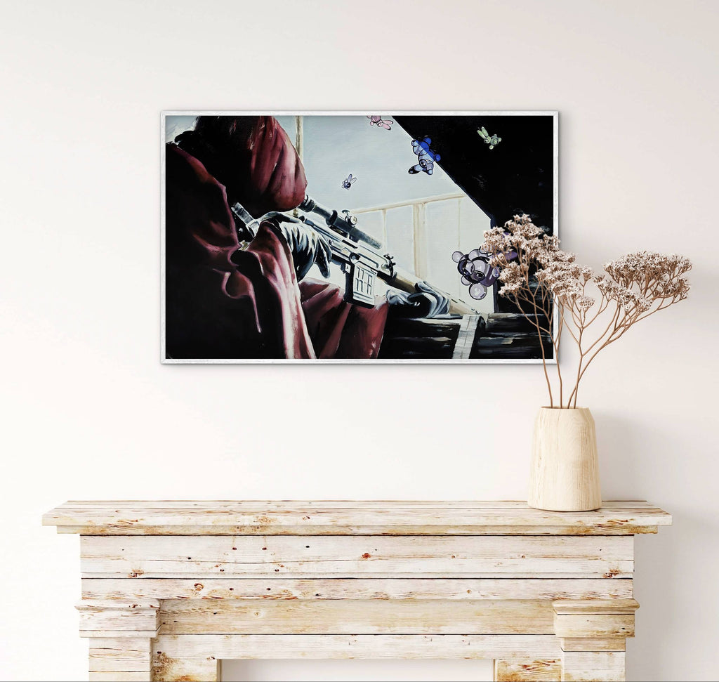 Framed artwork on a wall above a wooden console table with a vase of dried flowers.