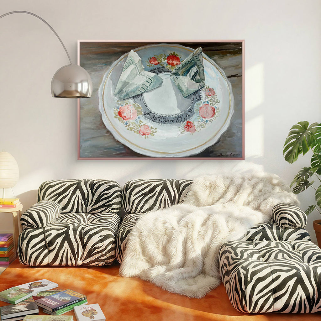 Living room with zebra-patterned sofa, white fur throw, and framed artwork on the wall.