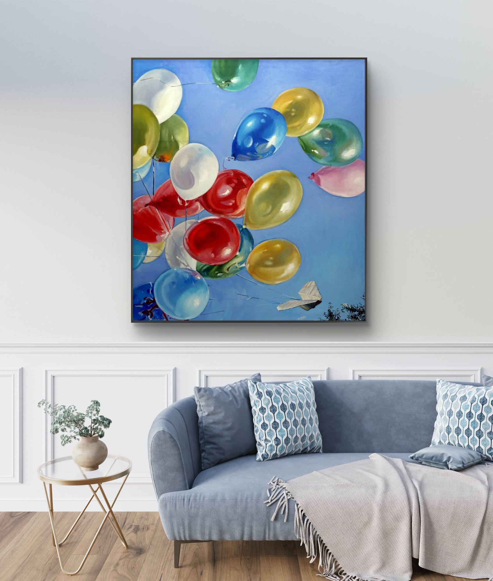 Colorful balloon painting on a wall above a sofa in a living room.
