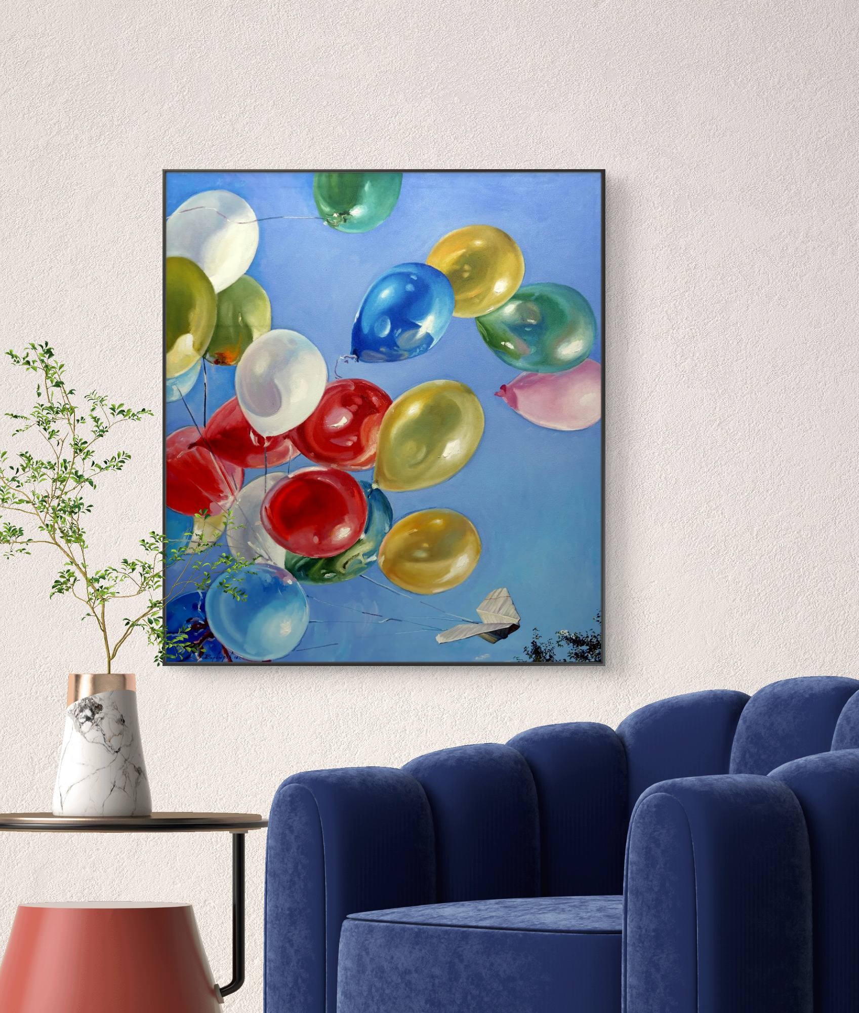 Framed artwork of colorful balloons on a wall above a blue armchair.
