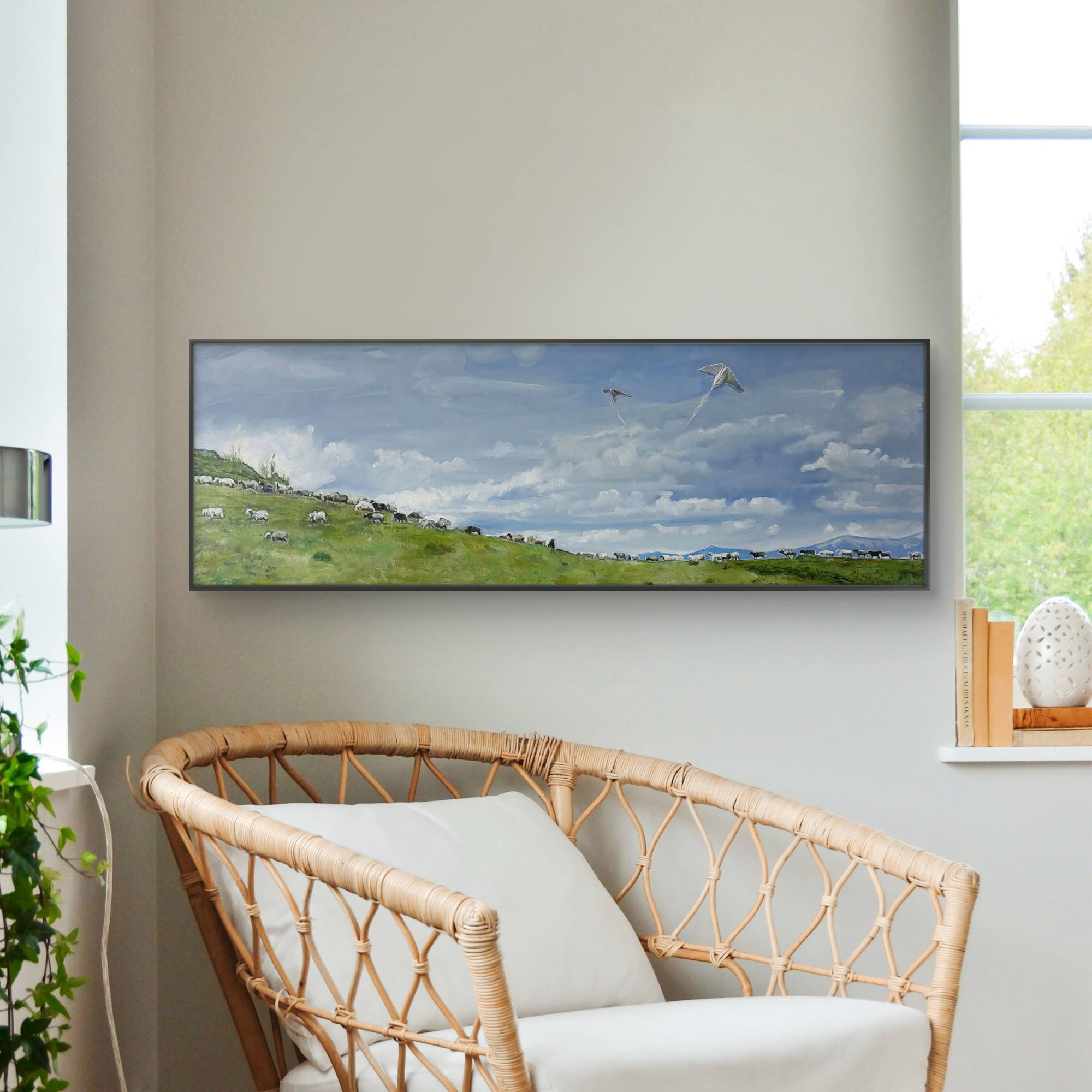 Living room with a flat-screen TV displaying a nature scene, a wicker chair, and a plant.