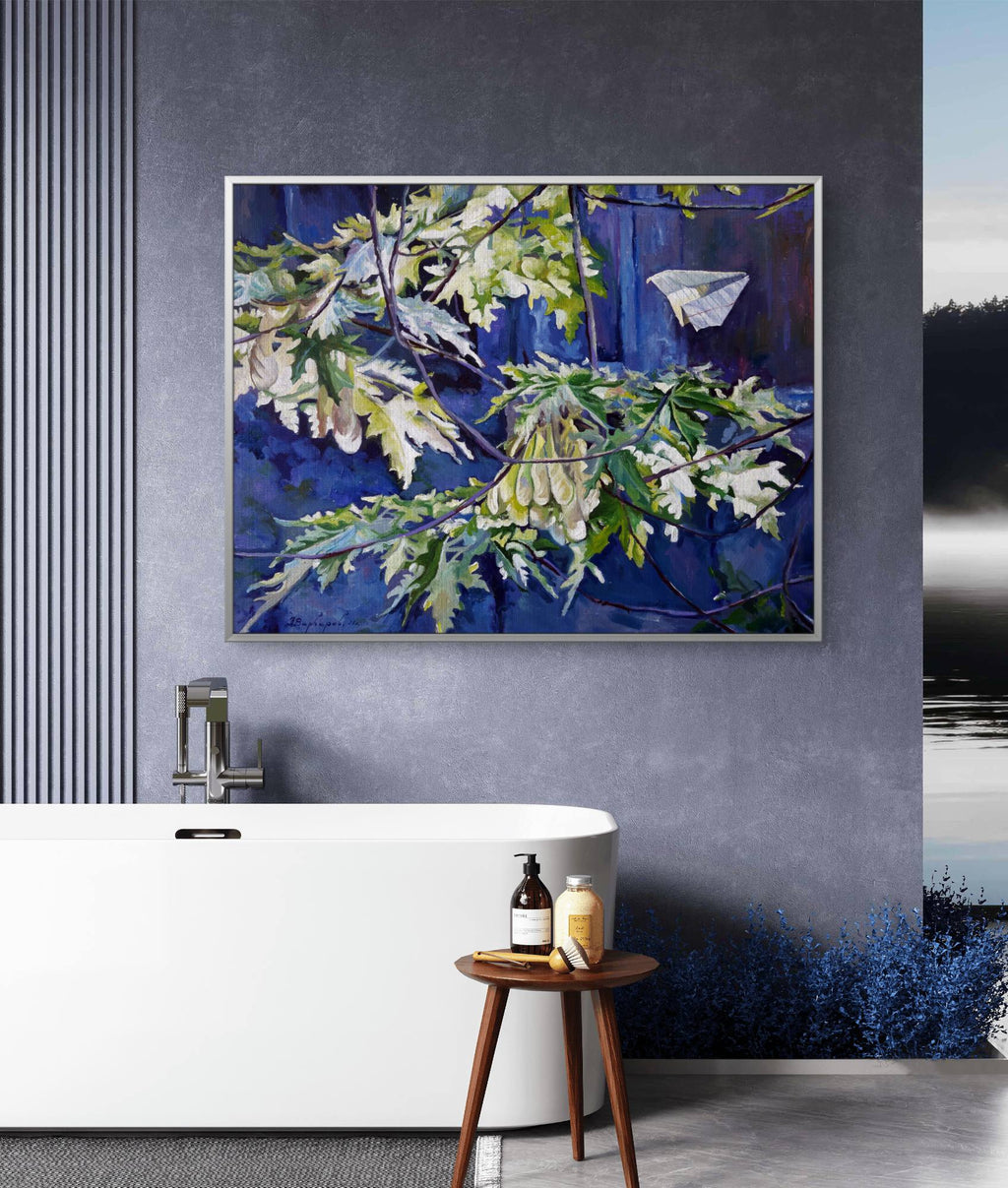 Framed artwork of leaves and a butterfly on a blue background in a modern bathroom.