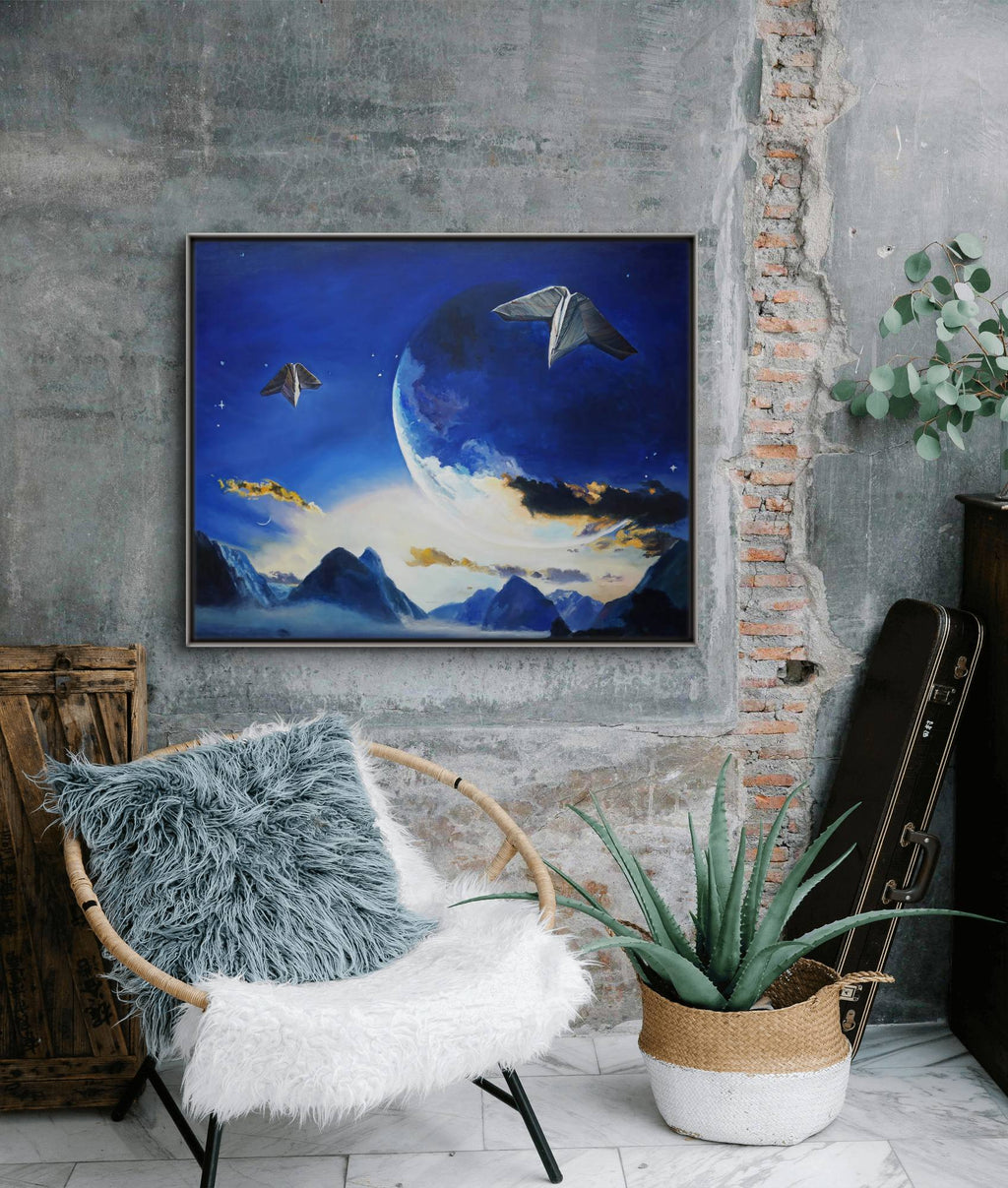 Framed artwork of a celestial scene on a wall above a chair with a fluffy cover.