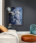 Modern living room with abstract art on the wall, a sofa, ottoman, and chair.