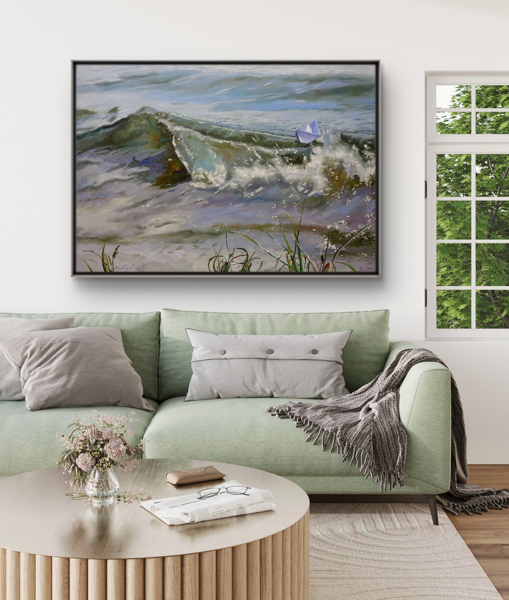 Living room with a green sofa, round wooden coffee table, and a large framed painting of a landscape.