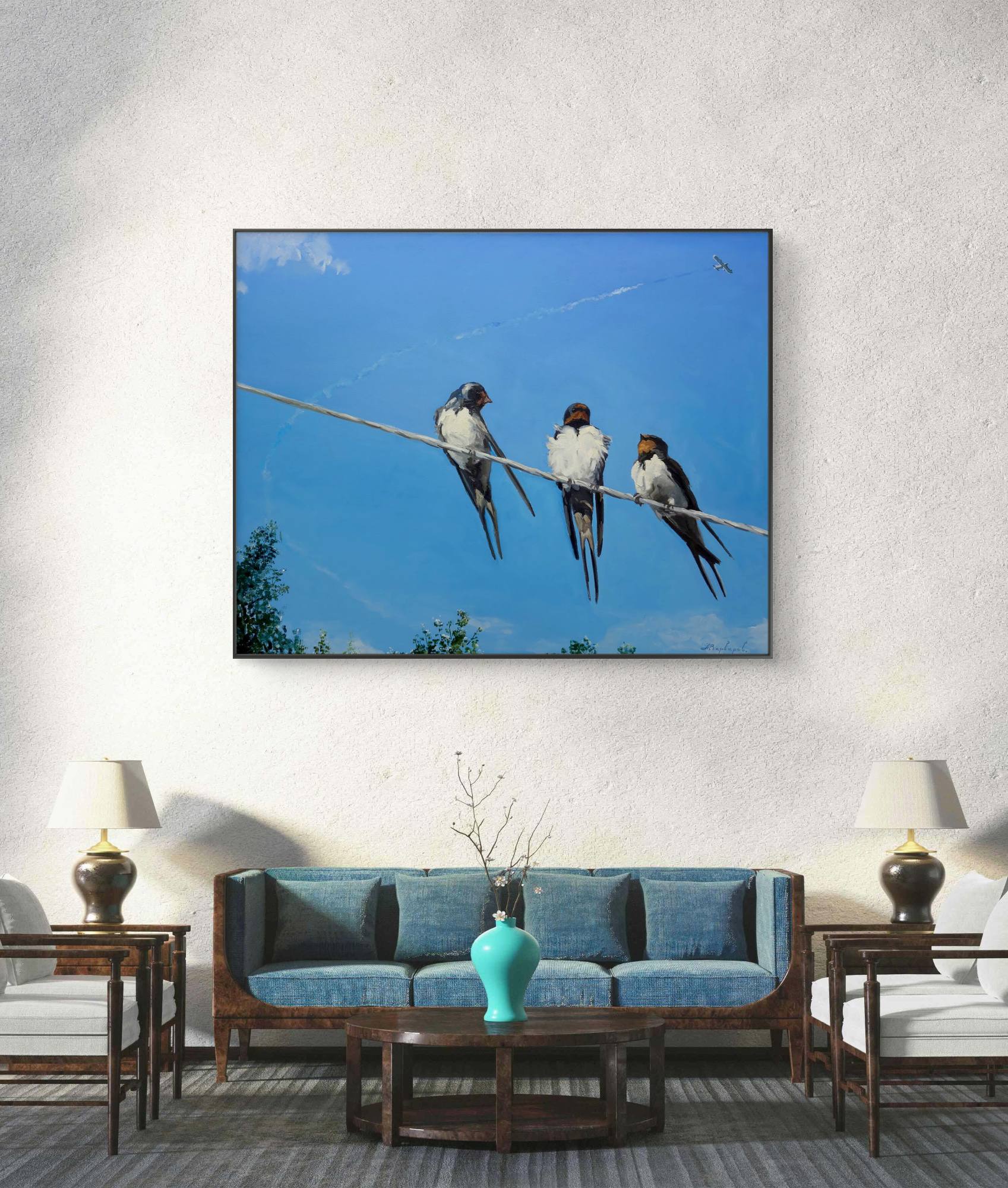 Framed artwork of birds on a wire above a living room setting.