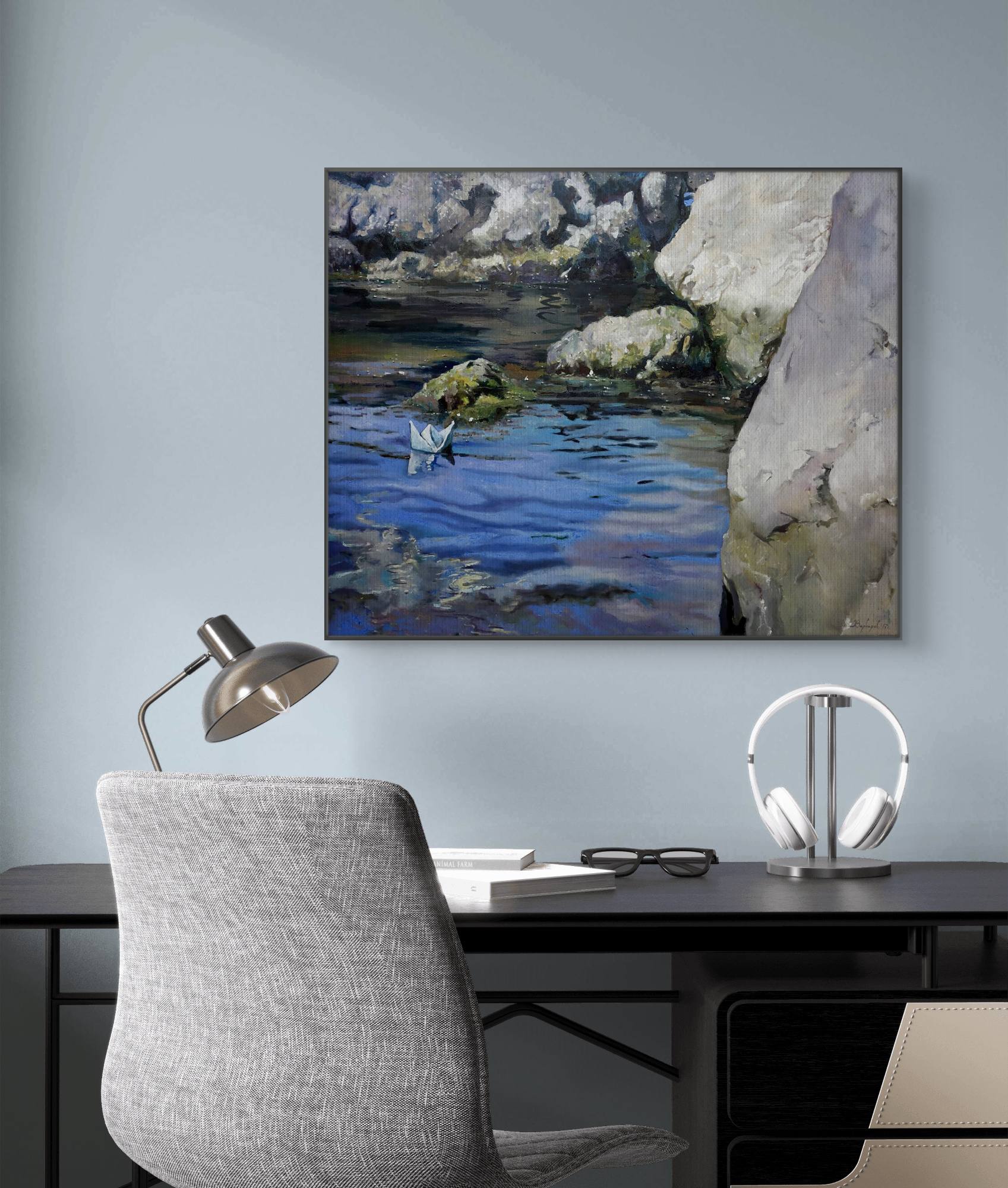 Artistic depiction of a landscape with water and rocks on a wall above a desk.