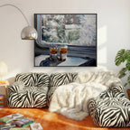 Living room with zebra-patterned sofa, white fur throw, and framed artwork of a train interior.