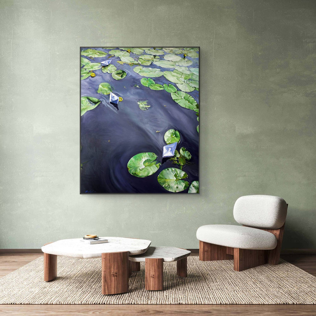Room interior with a painting of water lilies on a wall, a chair, and coffee table.