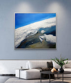 Abstract painting of a mountain landscape with a blue sky in a modern living room.