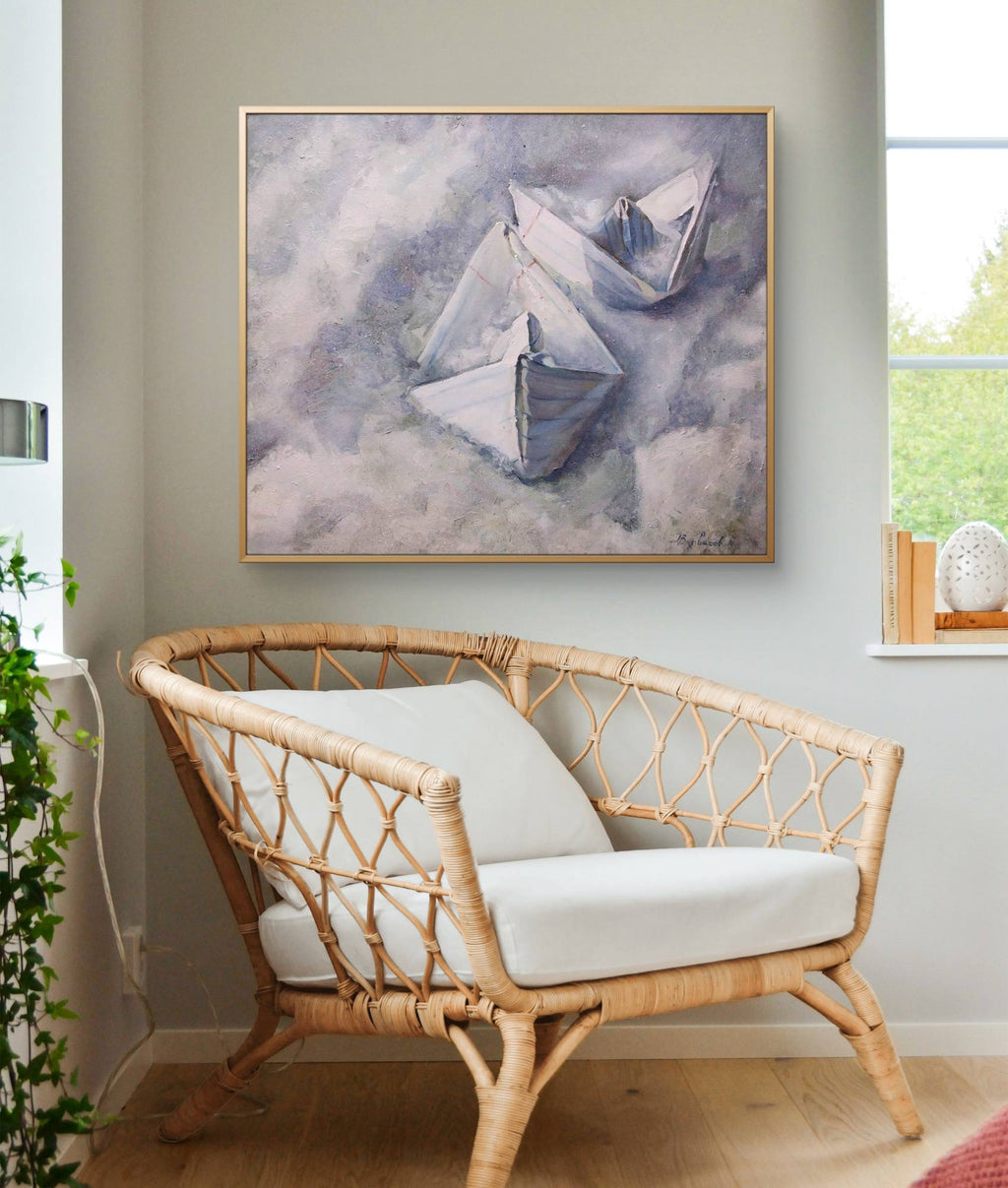 Rattan loveseat with white cushions in a room with a large abstract painting on the wall.