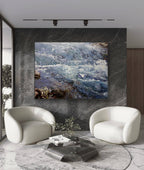 Modern living room with two white chairs and a coffee table in front of a large wall-mounted TV displaying a nature scene.