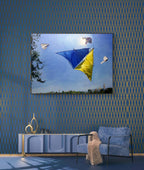 Living room with a large TV displaying a kite scene, blue walls with gold patterns, and modern furniture.