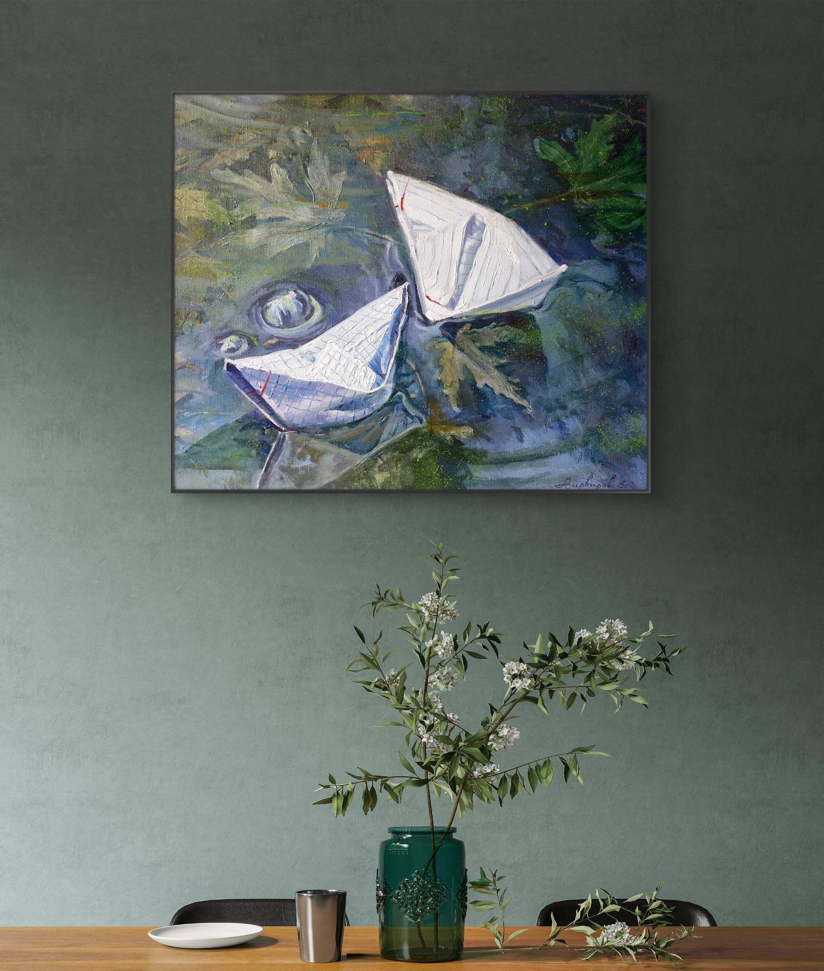 Abstract painting of a sailboat on a wall above a table with decor items.