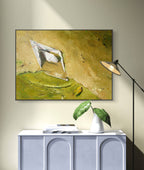 Framed abstract painting on a wall above a white cabinet with decorative items.