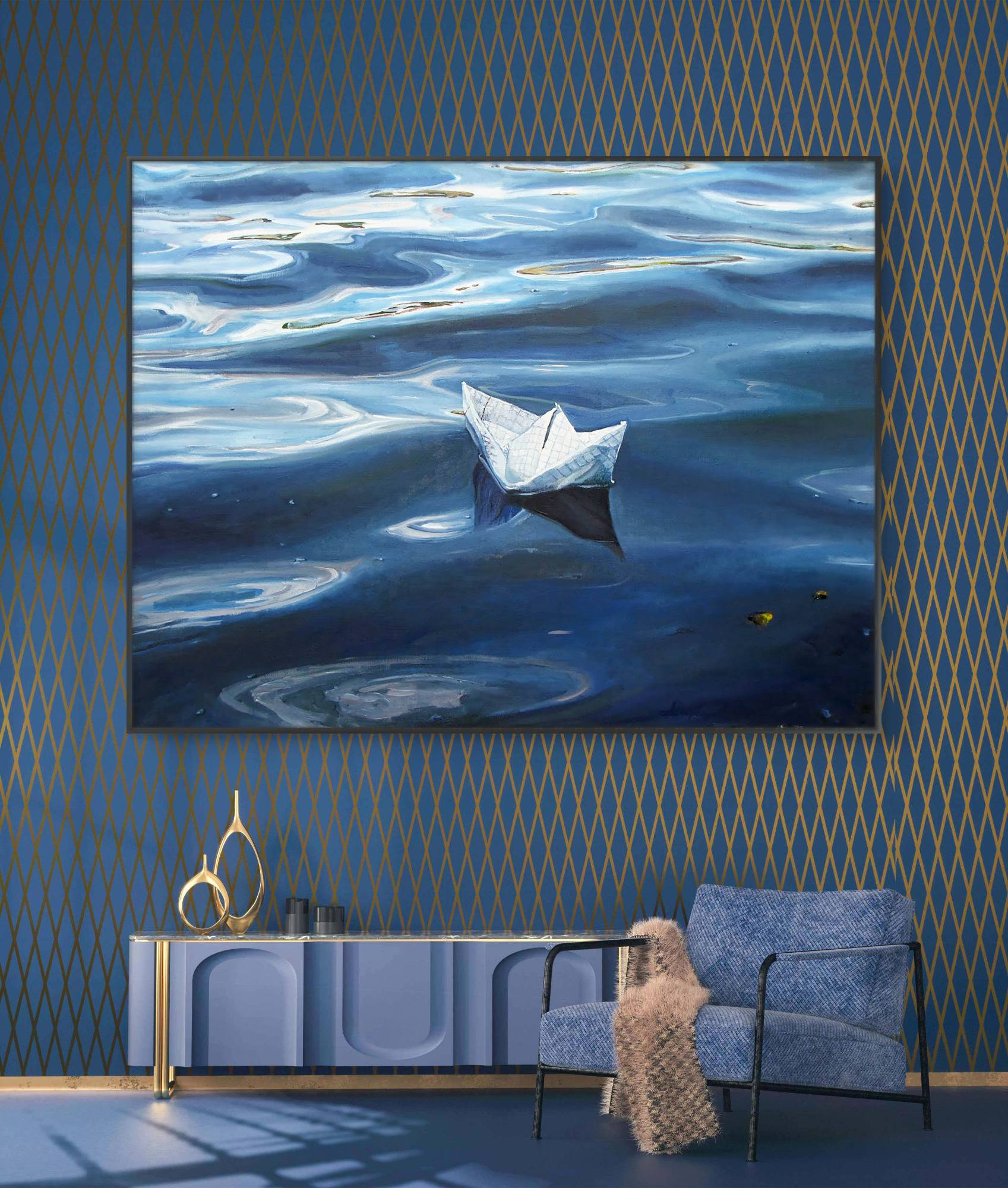Framed artwork of a paper boat on water in a room with blue walls and furniture.