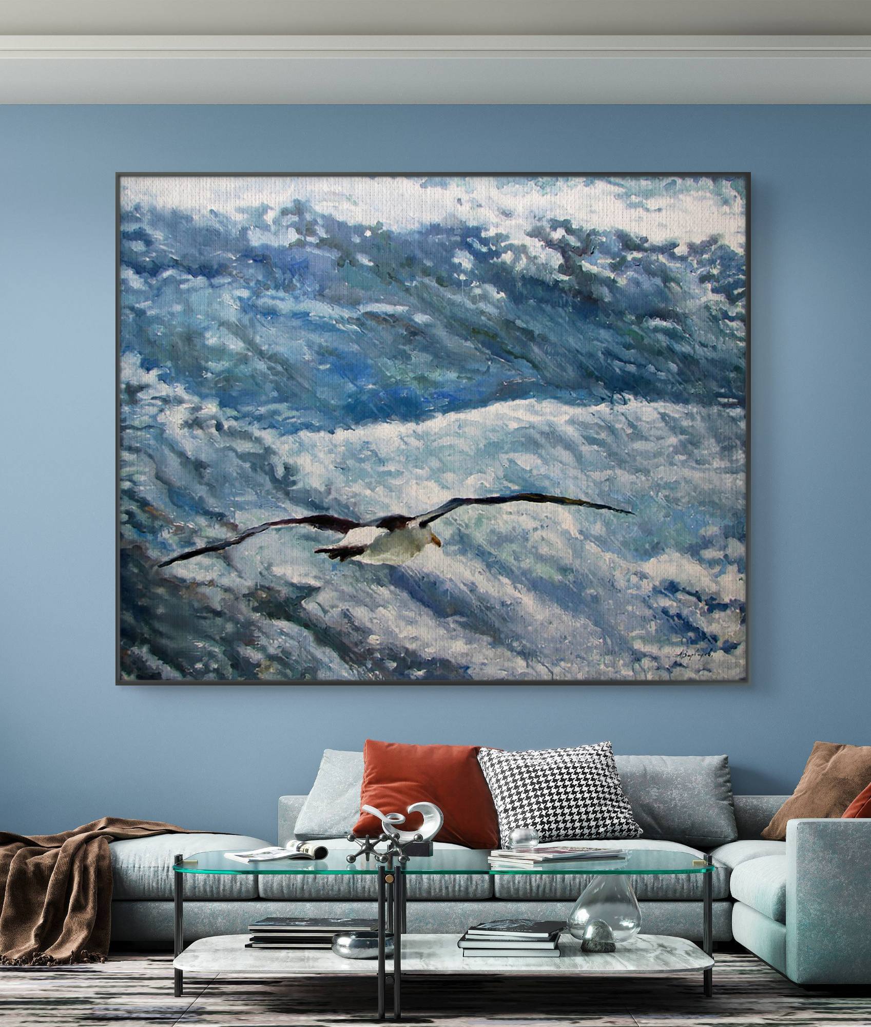 Framed artwork of a bird flying over water in a living room setting.