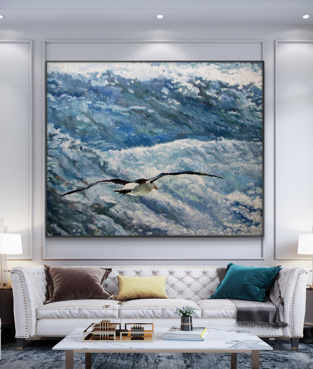Living room with a large abstract painting of a bird over water, white sofa with colorful pillows, and coffee table.