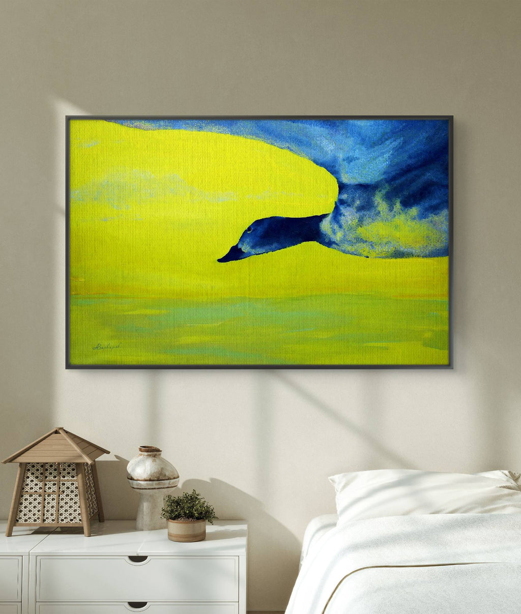 Framed abstract painting of a blue bird on a yellow background in a bedroom setting.