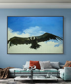 Framed artwork of an eagle in flight on a blue wall above a sofa.