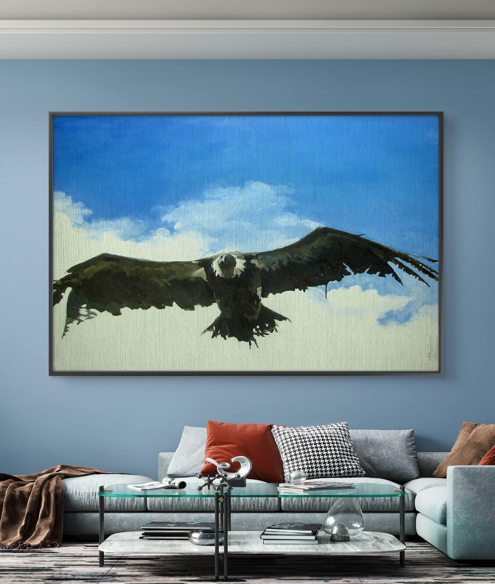 Framed artwork of an eagle in flight on a blue wall above a sofa.