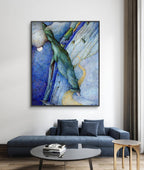 Abstract painting in a modern living room with a blue sofa and round coffee table.