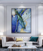 Modern living room with a white sofa, abstract painting, and decorative items.
