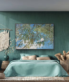 Bedroom with teal walls, bed, and decorative elements including a painting of trees and water.