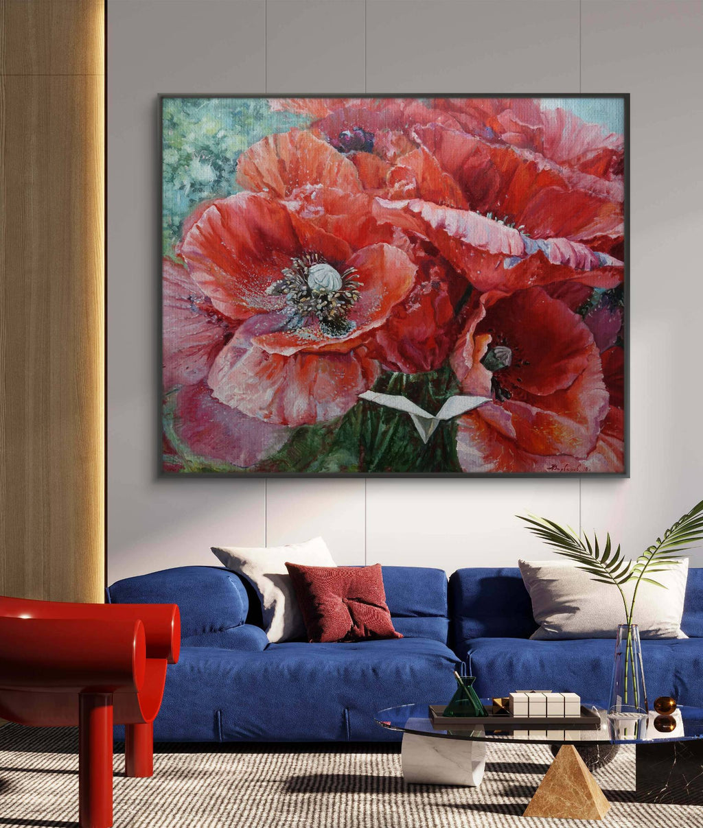Framed floral painting above a blue sofa in a living room.