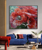 Framed floral painting above a blue sofa in a living room.