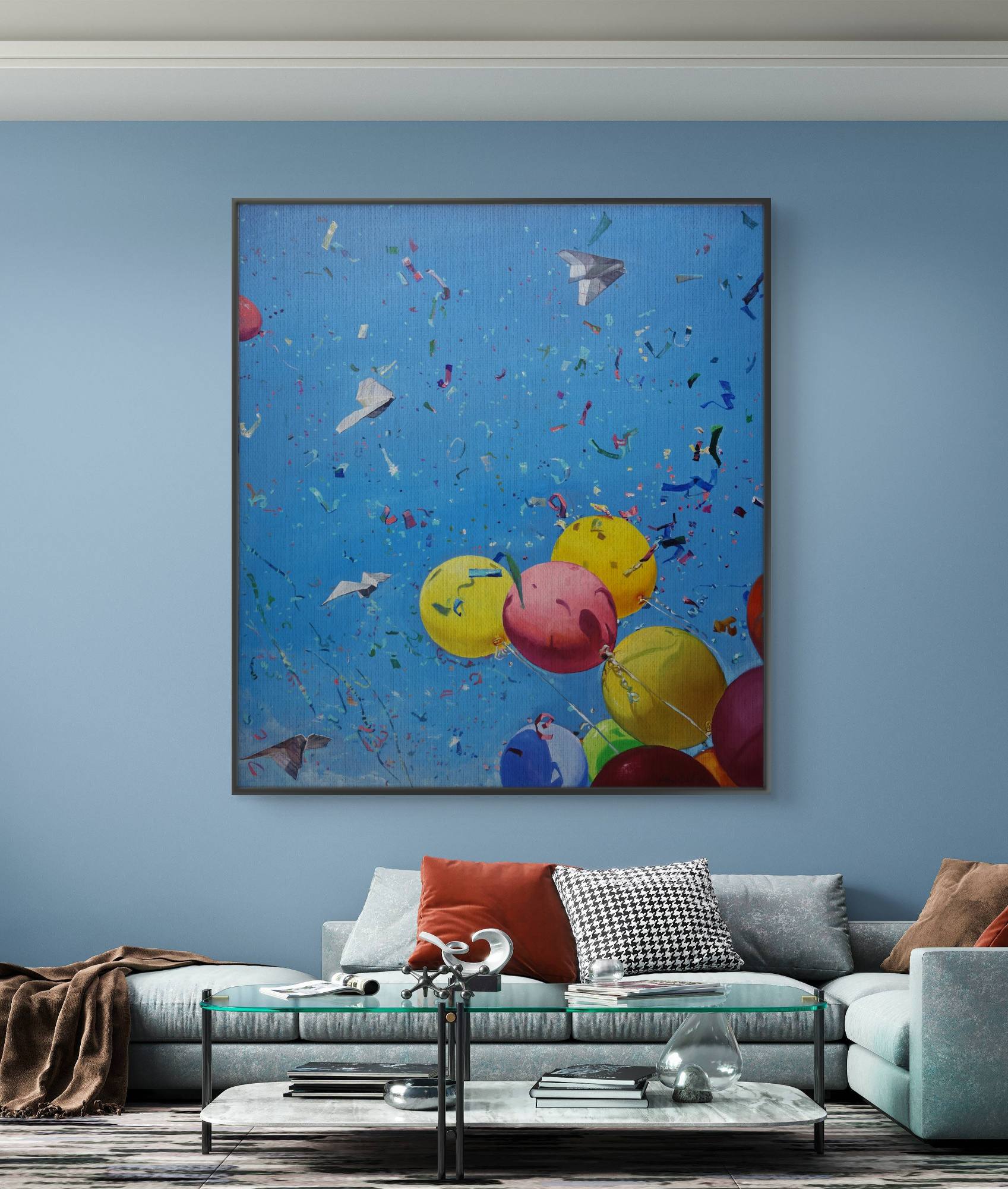 Colorful abstract painting of balloons and birds on a blue wall above a sofa.