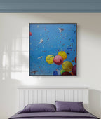 Colorful abstract painting of balloons and butterflies above a bed with purple bedding.
