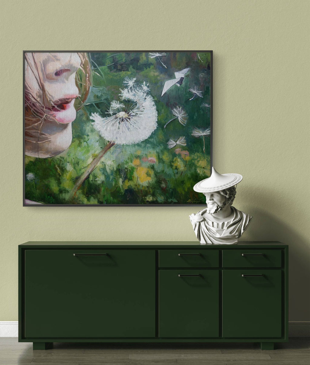 Framed artwork of a dandelion on a wall above a green cabinet with a classical statue.
