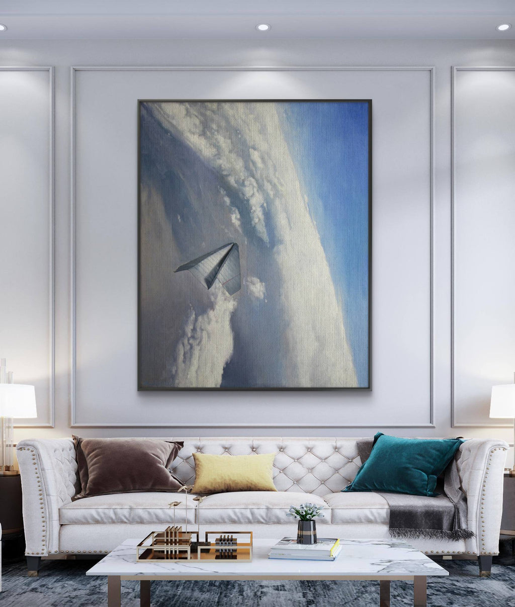 Modern living room with a white sofa, coffee table, and large framed artwork on the wall.
