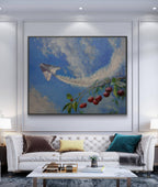 Framed artwork of a cherry branch with a kite against a blue sky in a living room.