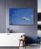 Framed artwork of a paper airplane against a blue sky in a modern bathroom.