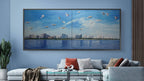 Living room with a large wall art piece depicting a city skyline and water.