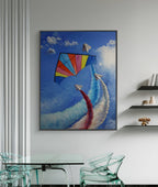 Framed artwork of a colorful kite against a blue sky with clouds in a modern interior setting.