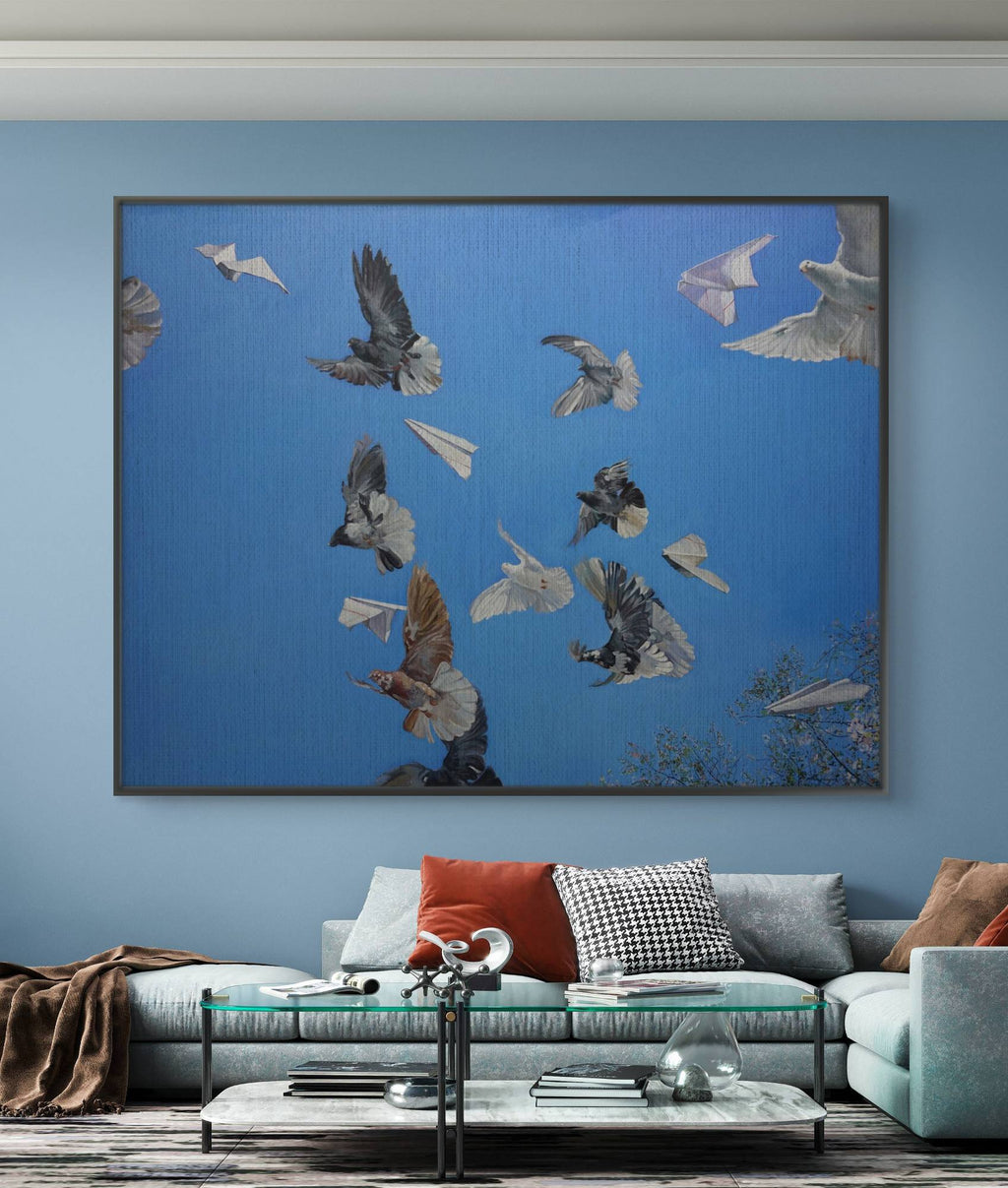 Framed artwork of birds on a blue background in a living room.