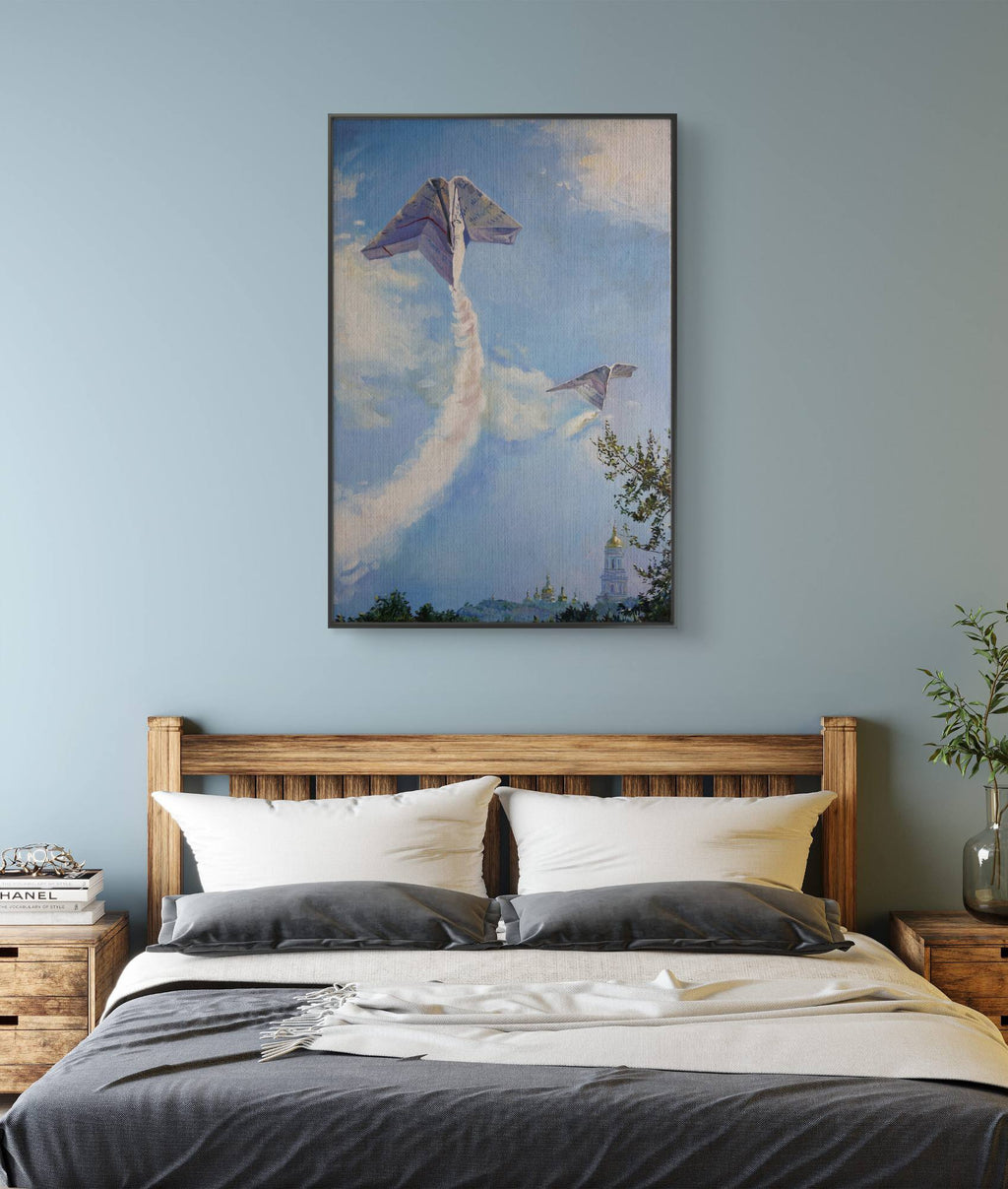 Bedroom with wooden headboard, gray bedding, and a large painting of airplanes on the wall.