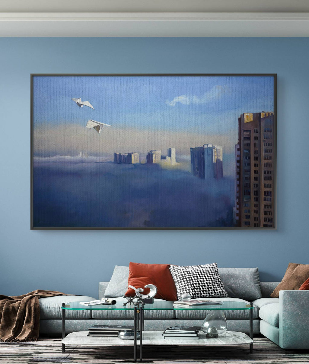 Framed artwork of a cityscape with airplanes above clouds in a living room.