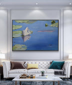 Living room with a large framed painting of a lily pad scene above a white sofa.