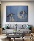 Living room with a gray sofa, round wooden coffee table, and a large abstract painting on the wall.