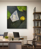 Modern office interior with a desk, computer, and bookshelf featuring a painting of a flower and leaves.