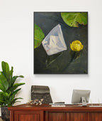 Framed artwork of a still life with flowers on a wall above a desk.