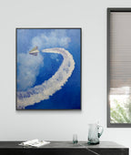 Framed abstract artwork on a wall with a window and table in the foreground