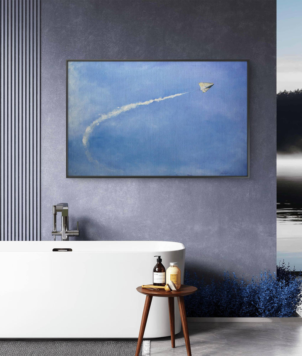 Framed artwork of a kite flying in the sky above a modern bathroom with a bathtub and stool.